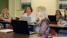 Graduate students listen to lecture